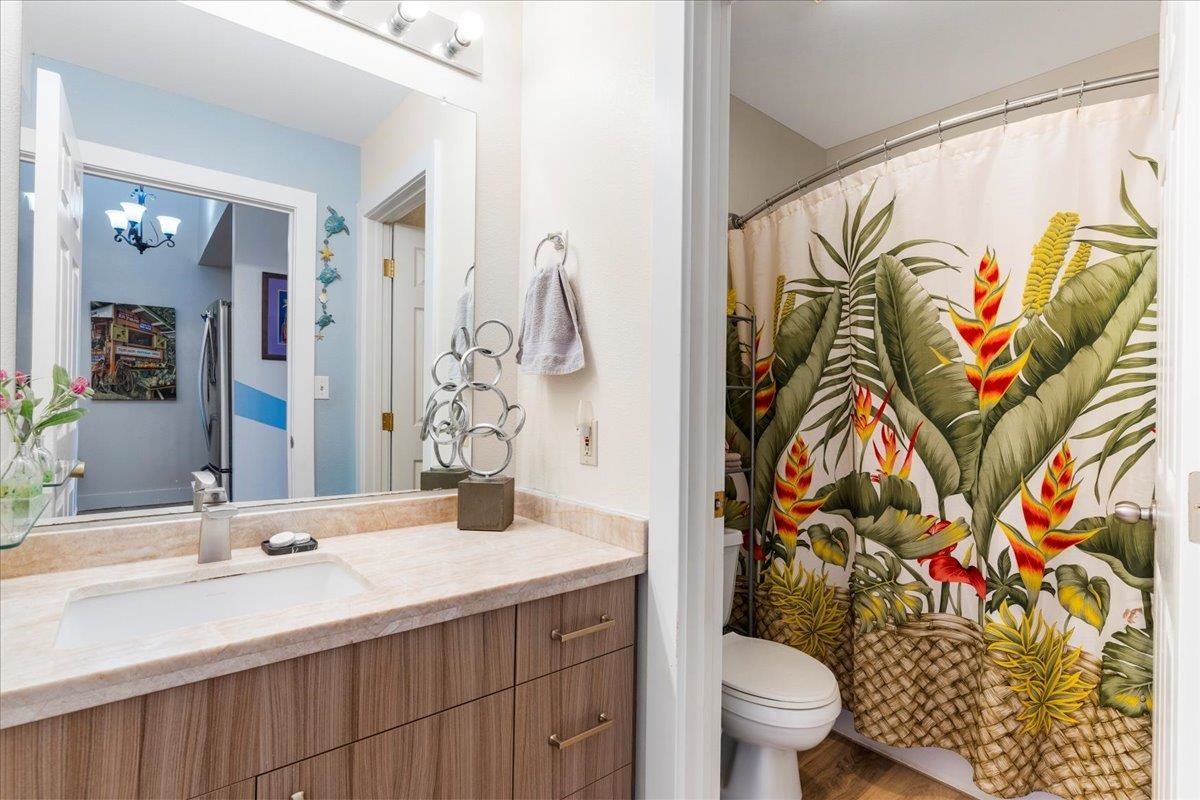 679 South Kihei Road, Unit D203 Kihei, HI 96753 - Photo 42 of 46 a bathroom with a sink and a blue curtain