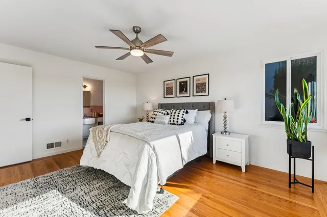a bedroom with a bed and a ceiling fan