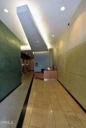 a lobby with a couch and a rug