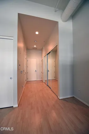 a view of empty room with wooden floor