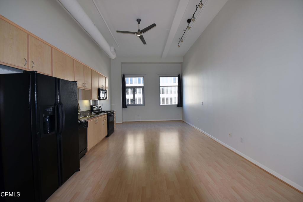 175 South Lake Avenue, Unit 406 Pasadena, CA 91101 - Photo 9 of 12 a view of a kitchen with a refrigerator and windows