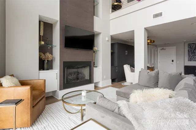a living room with furniture fireplace and a flat screen tv