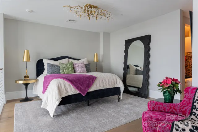 a bed room with a bed and a potted plant