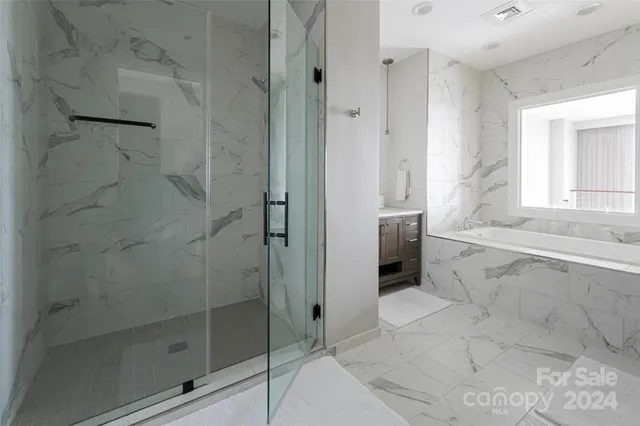 a bathroom with a bathtub and a shower