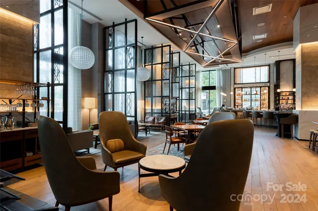 a living room with furniture and a floor to ceiling window