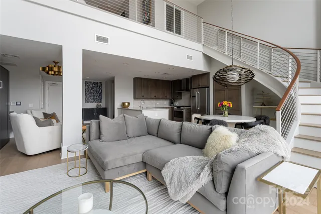 a living room with furniture and a chandelier