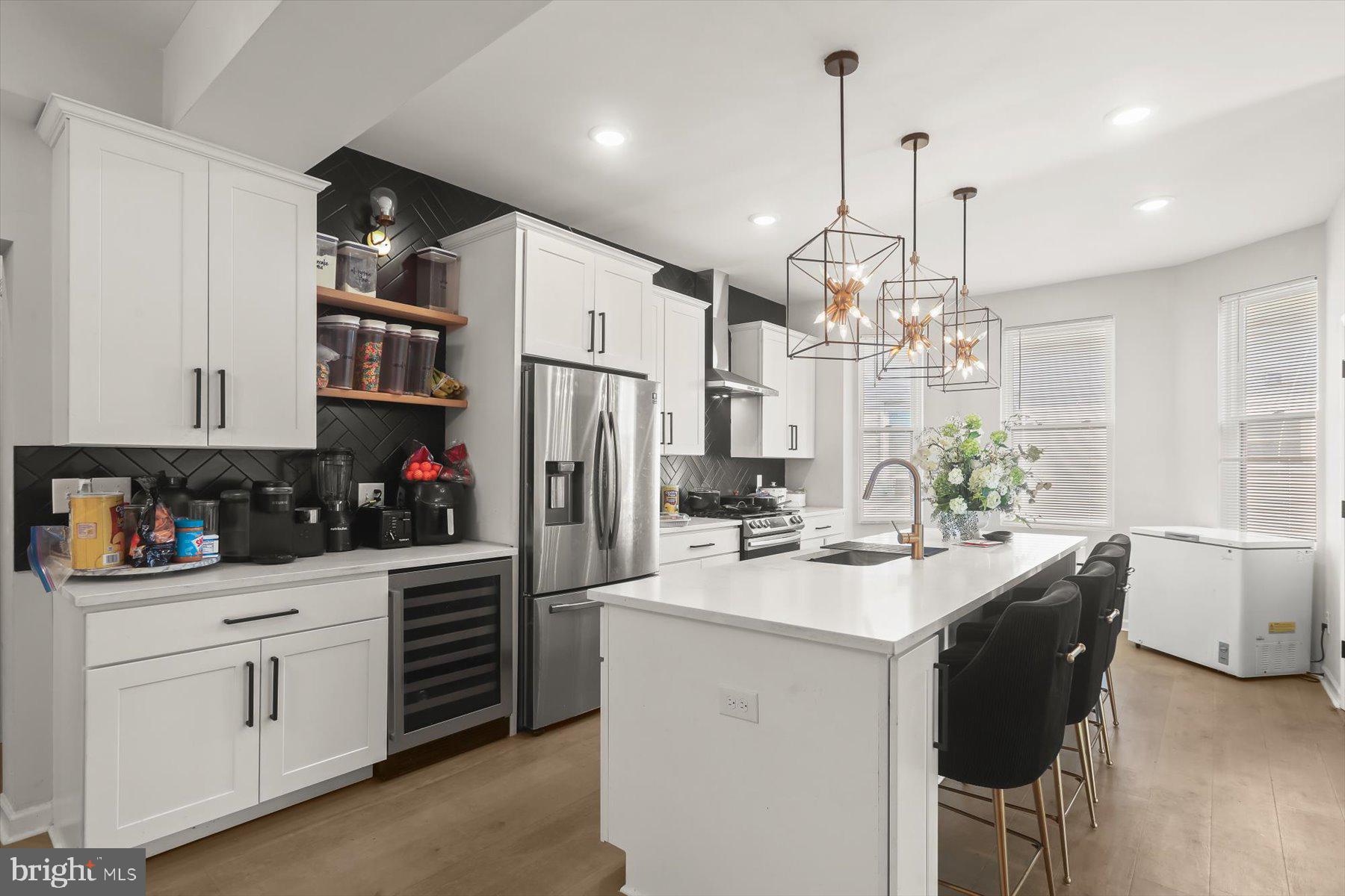 4006 Springdale Avenue Baltimore, MD 21207 - Photo 11 of 40 a kitchen with stainless steel appliances kitchen island granite countertop a sink and cabinets