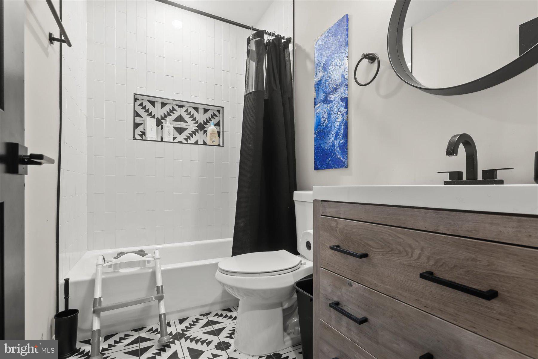 4006 Springdale Avenue Baltimore, MD 21207 - Photo 19 of 40 a bathroom with a sink a toilet and a mirror