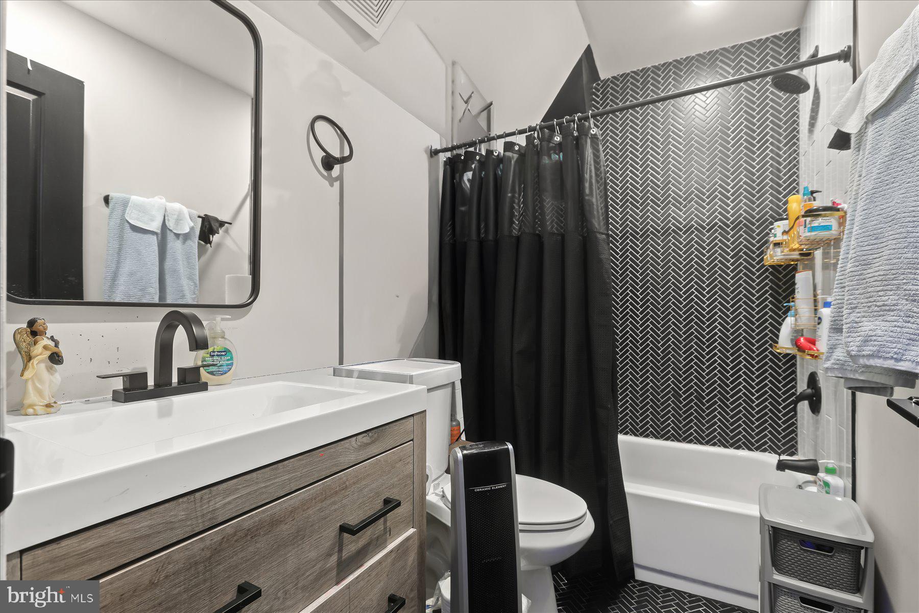 4006 Springdale Avenue Baltimore, MD 21207 - Photo 21 of 40 a bathroom with a sink toilet and shower