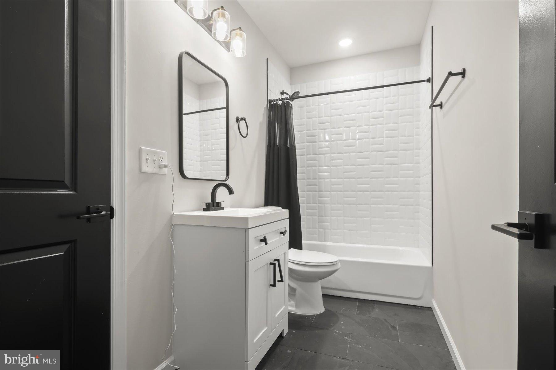 4006 Springdale Avenue Baltimore, MD 21207 - Photo 23 of 40 a bathroom with a toilet sink shower and mirror