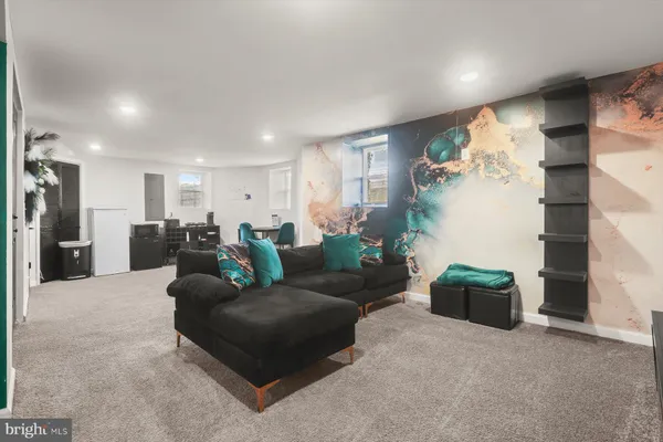 a living room with furniture and a ceiling fan