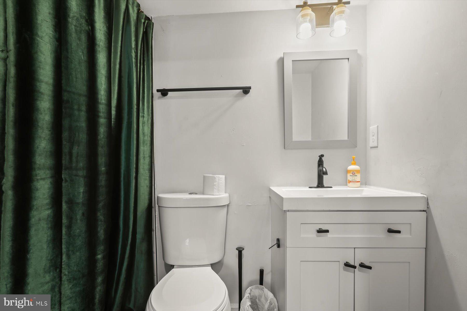 4006 Springdale Avenue Baltimore, MD 21207 - Photo 28 of 40 a bathroom with a toilet a sink and mirror