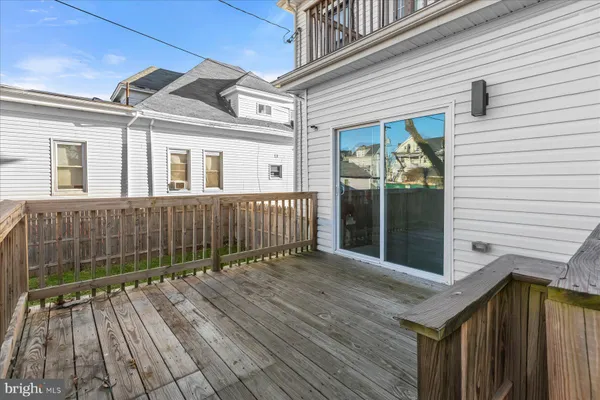 a view of a street with wooden fence