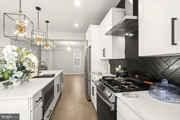 a kitchen with a sink and refrigerator