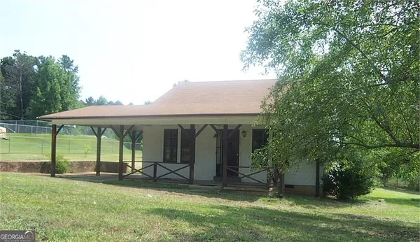 an outdoor view of house with yard and outdoor seating