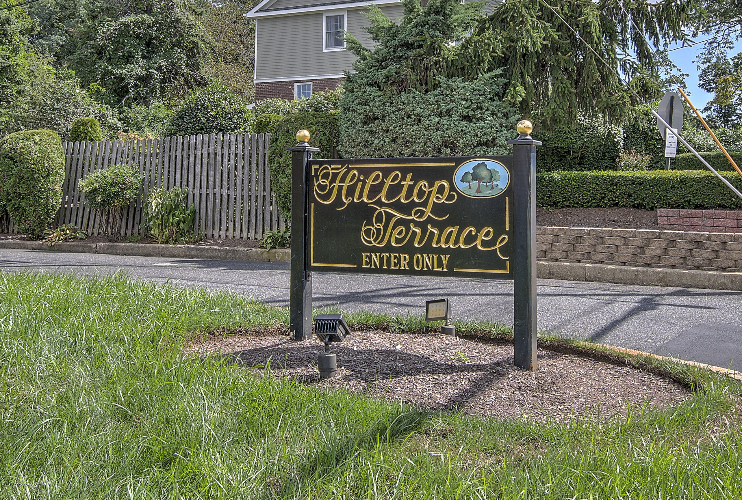321 Spring Street, Unit 12 Red Bank, NJ 07701 - Photo 1 of 24 a sign that is sitting on a brick wall