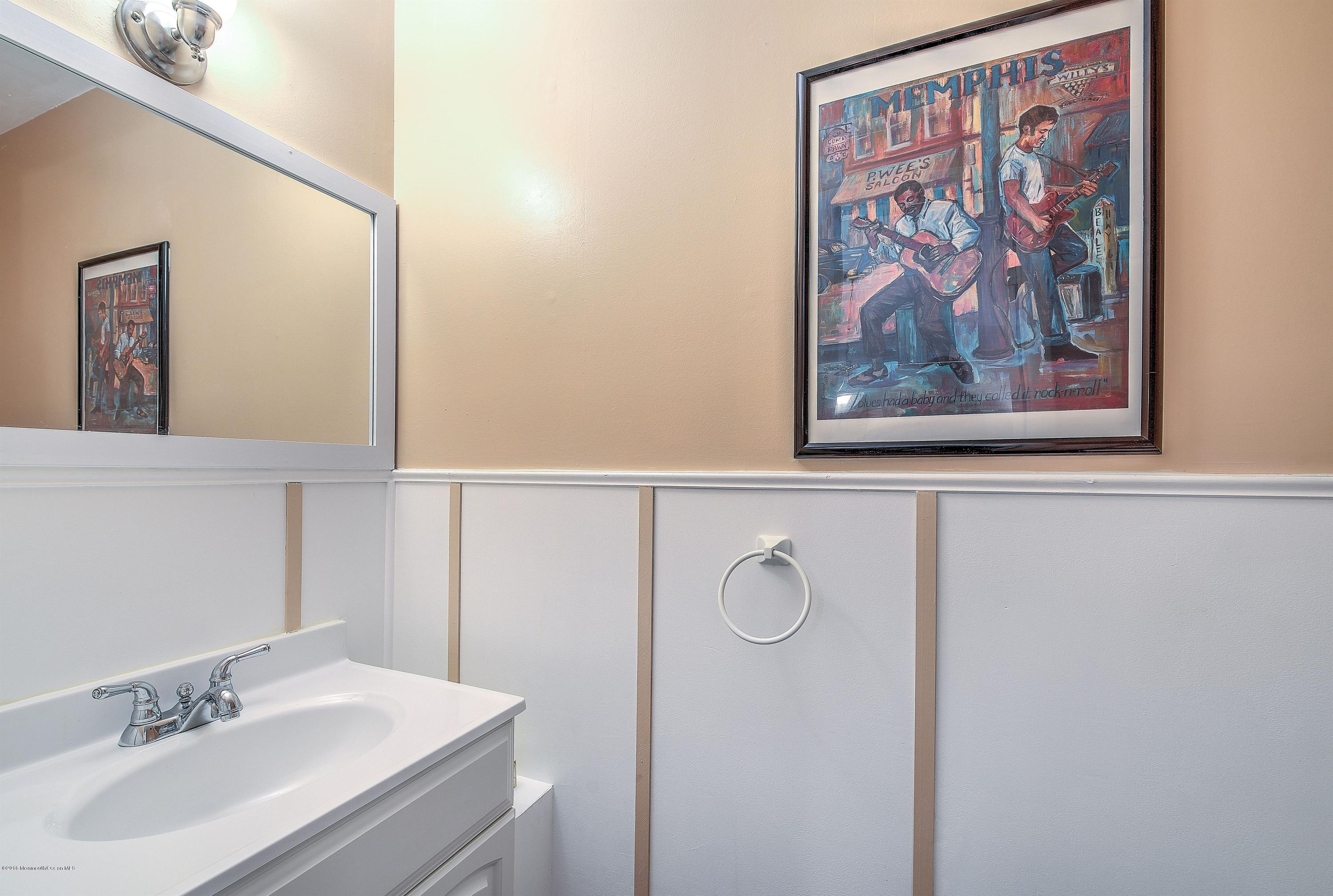 321 Spring Street, Unit 12 Red Bank, NJ 07701 - Photo 15 of 24 a bathroom with a sink and a mirror