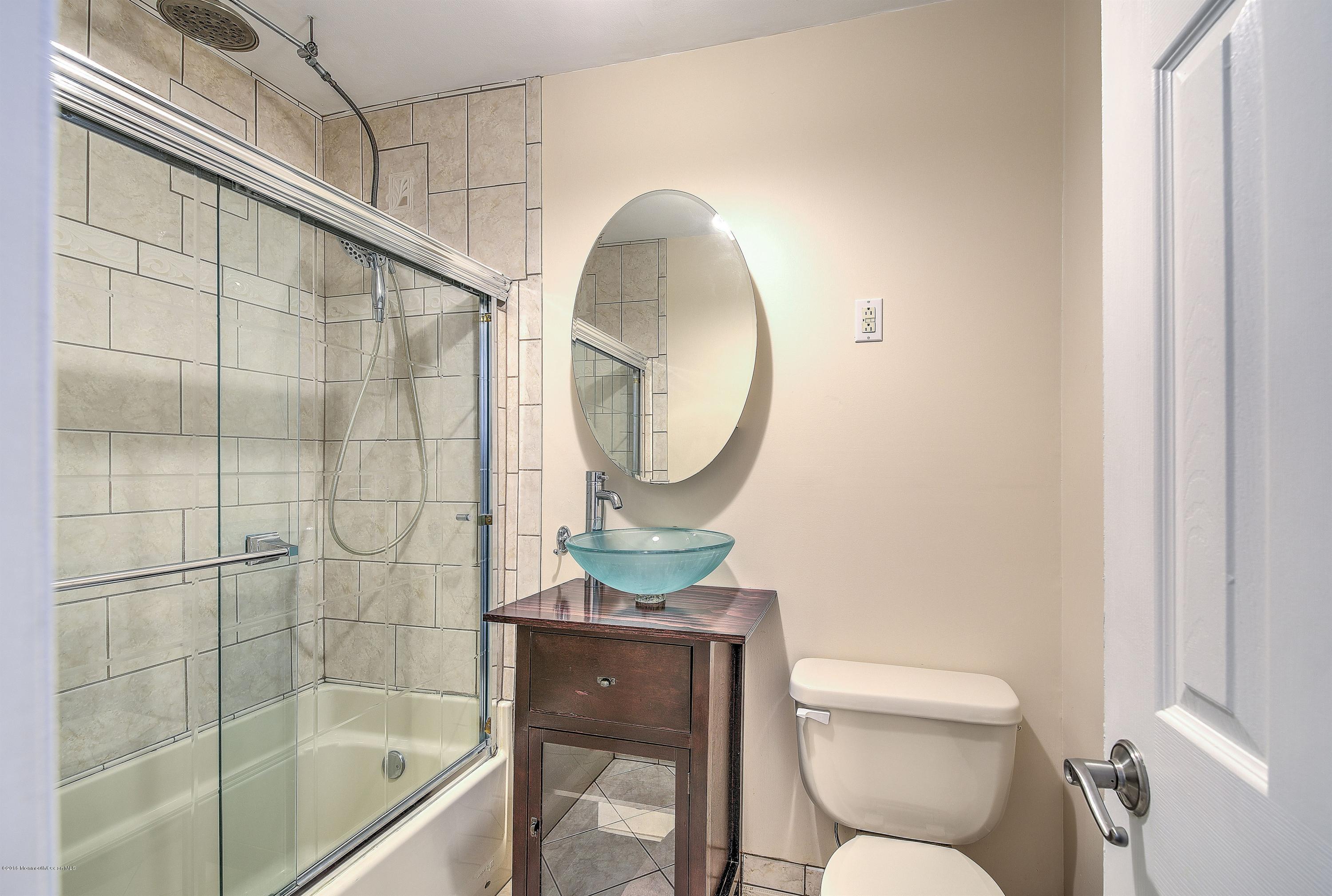 321 Spring Street, Unit 12 Red Bank, NJ 07701 - Photo 17 of 24 a bathroom with a toilet sink and shower