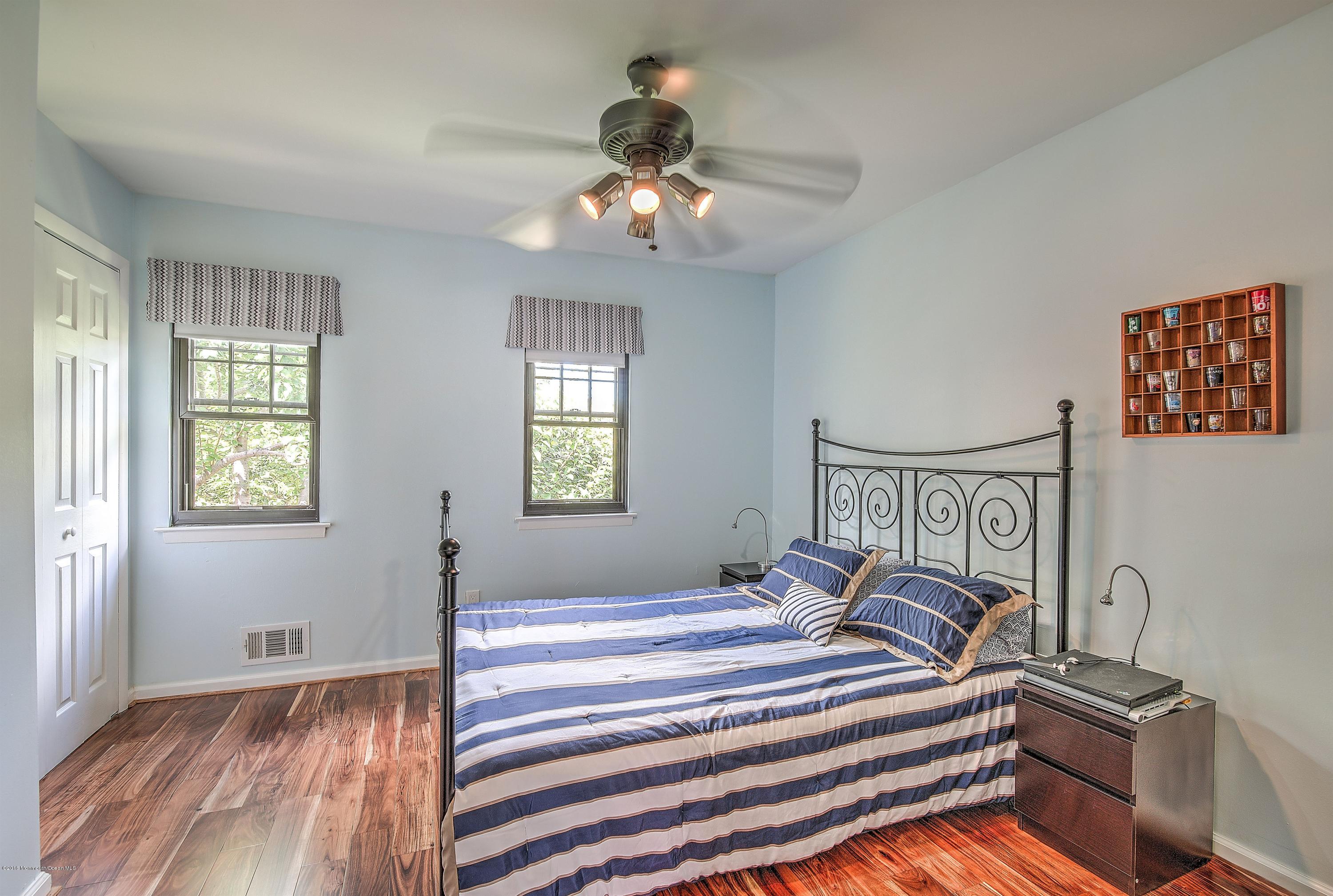 321 Spring Street, Unit 12 Red Bank, NJ 07701 - Photo 18 of 24 a bedroom with a bed and a window