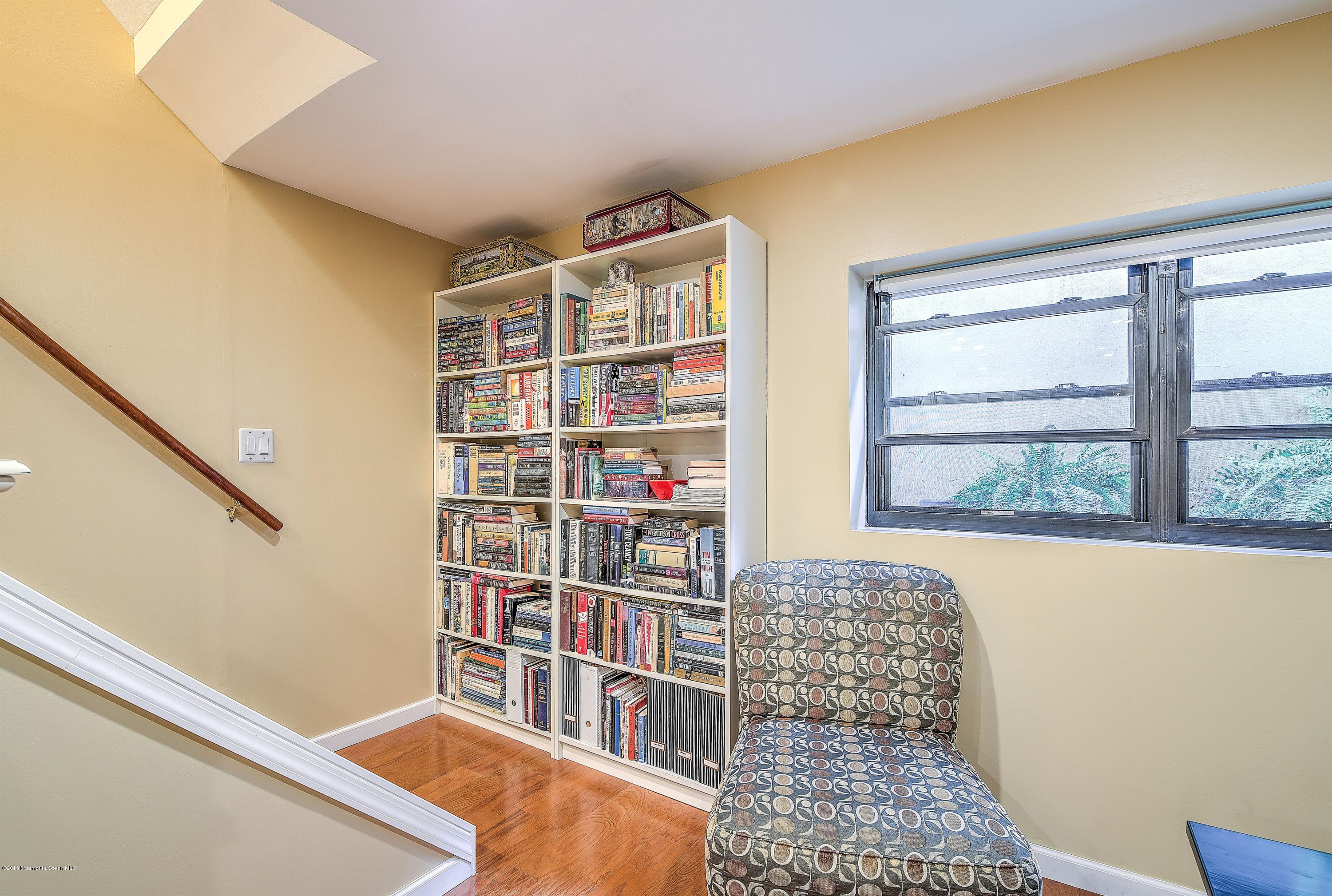 321 Spring Street, Unit 12 Red Bank, NJ 07701 - Photo 21 of 24 a living room with fish tank and a bookshelf
