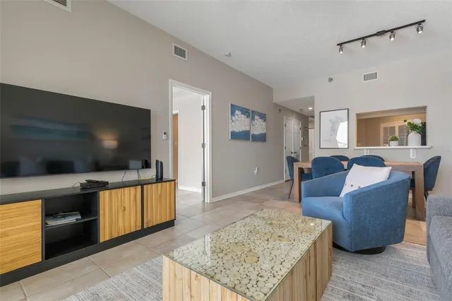 a kitchen with a sink a refrigerator and cabinets