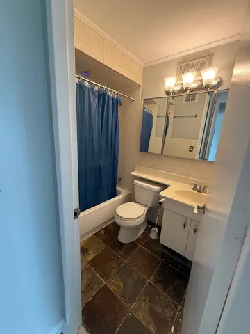 a bathroom with a toilet a sink and a shower