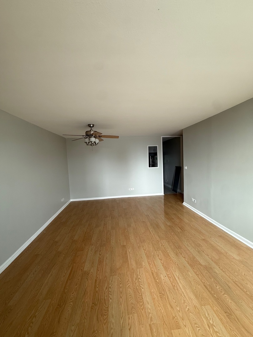 720 West Gordon Terrace, Unit 12A Chicago, IL 60613 - Photo 6 of 16 a view of empty room with wooden floor