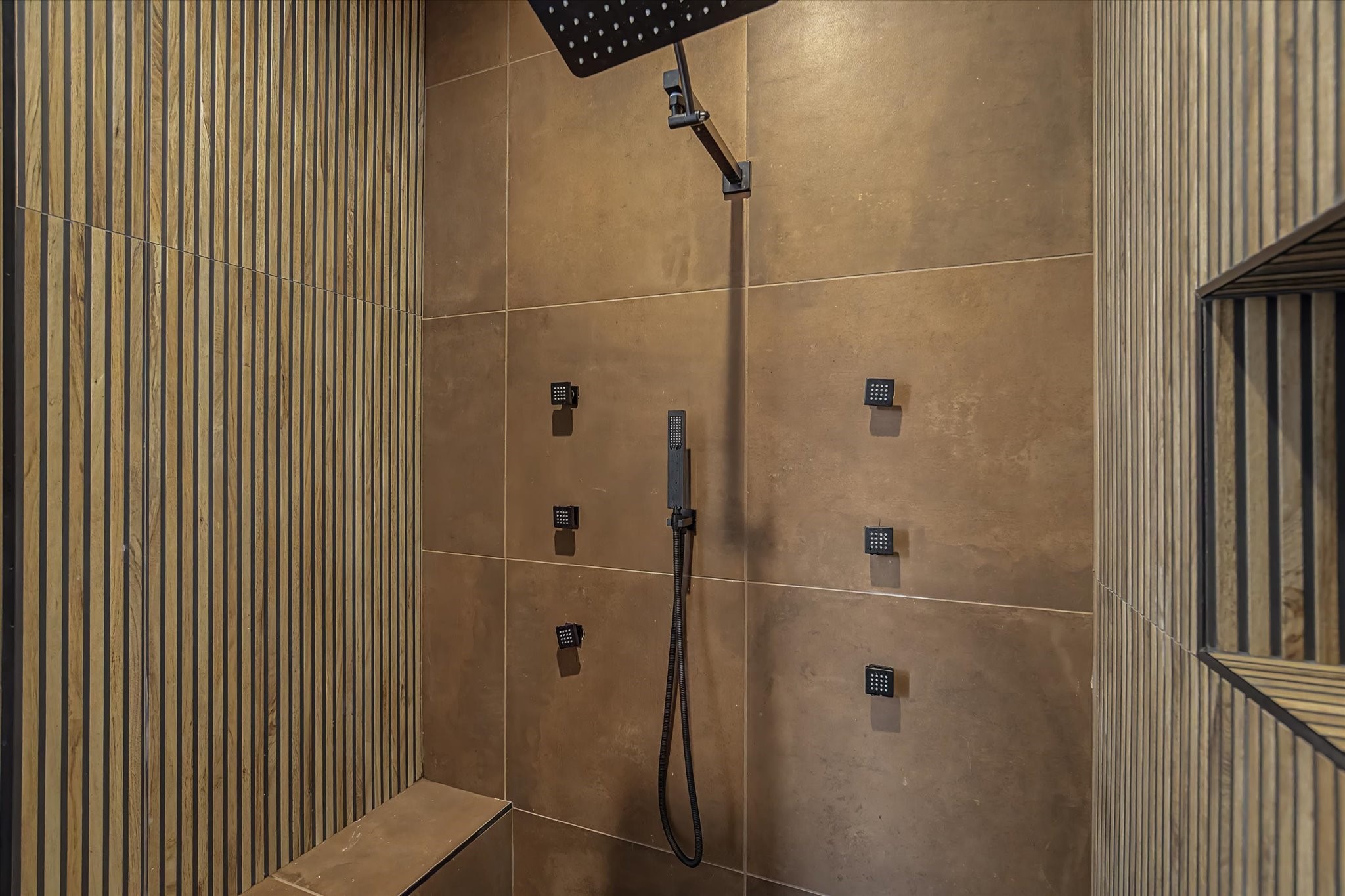 3806 Dreyfus Street Houston, TX 77021 - Photo 29 of 48 Luxury master bathroom featuring a rainfall shower head, multiple wall-mounted body jets, and a convenient handheld sprayer, all managed by a digital temperature control system.
