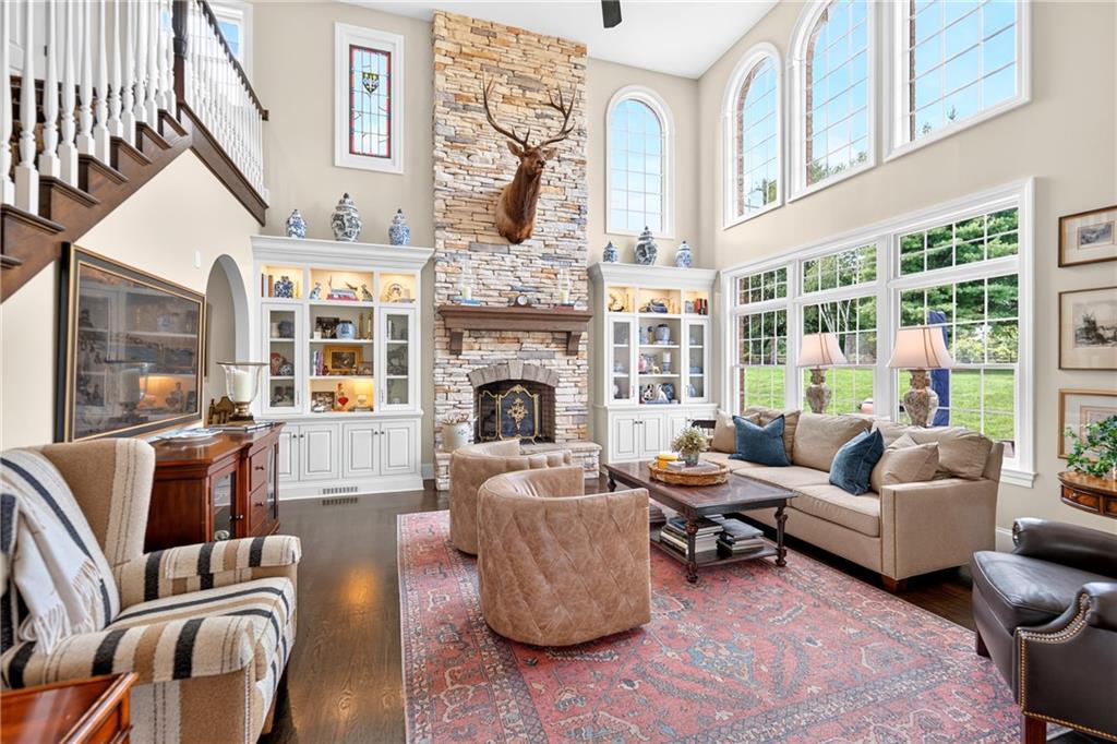 You have to see this 2 Story Family Room to believe it!  18x18, Hardwood Floors, Windows everywhere, Stone (working) Fireplace, custom mantel, fabulous Custom lighted built in Bookshelves.