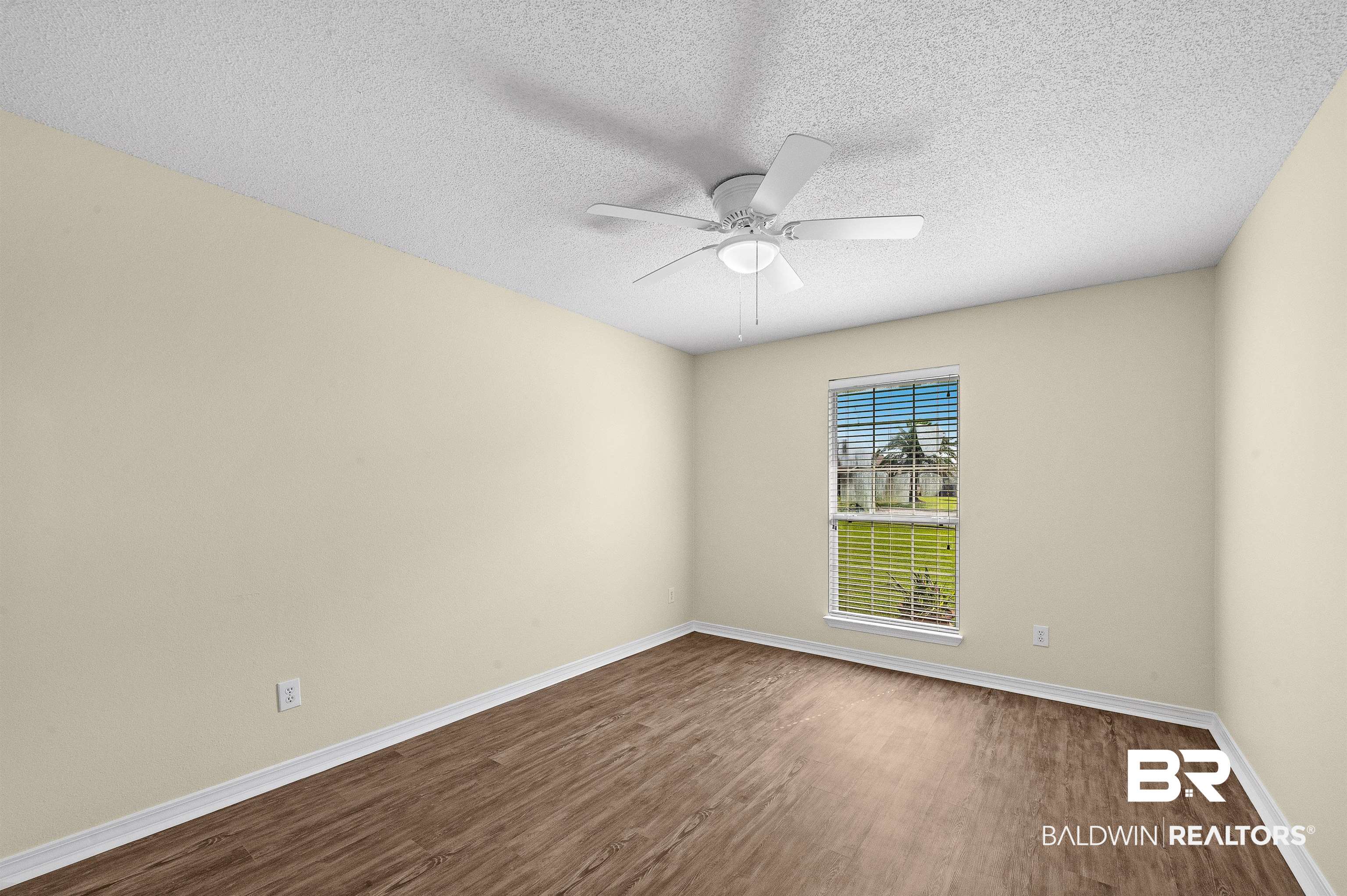 12443 Venice Boulevard Foley, AL 36535 - Photo 48 of 59 Spare room with hardwood / wood-style floors, ceiling fan, and a textured ceiling