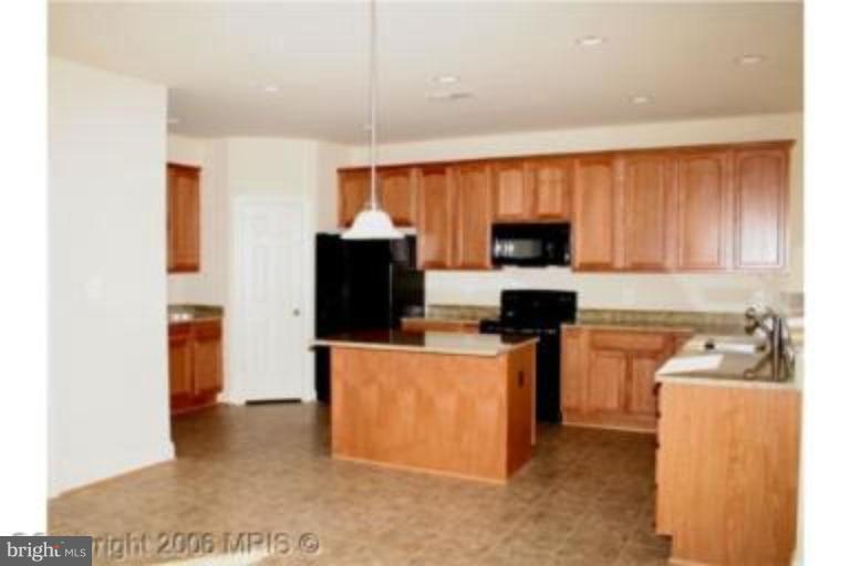 124 Holiday Road Cross Junction, VA 22625 - Photo 3 of 14 a kitchen with stainless steel appliances granite countertop a refrigerator stove top oven a sink and dishwasher