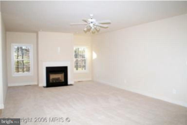 124 Holiday Road Cross Junction, VA 22625 - Photo 9 of 14 a view of an empty room with a fireplace and a window