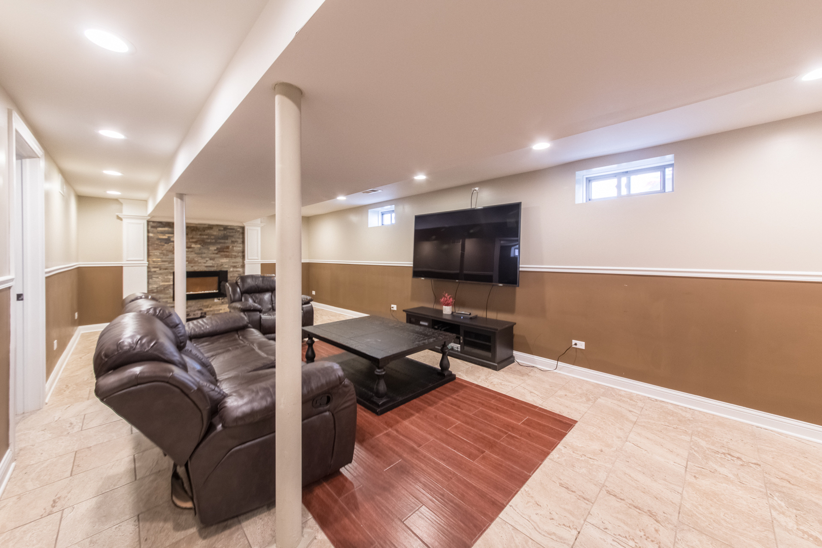 8653 North Merrill Street Niles, IL 60714 - Photo 16 of 19 a living room with furniture a flat screen tv and kitchen view