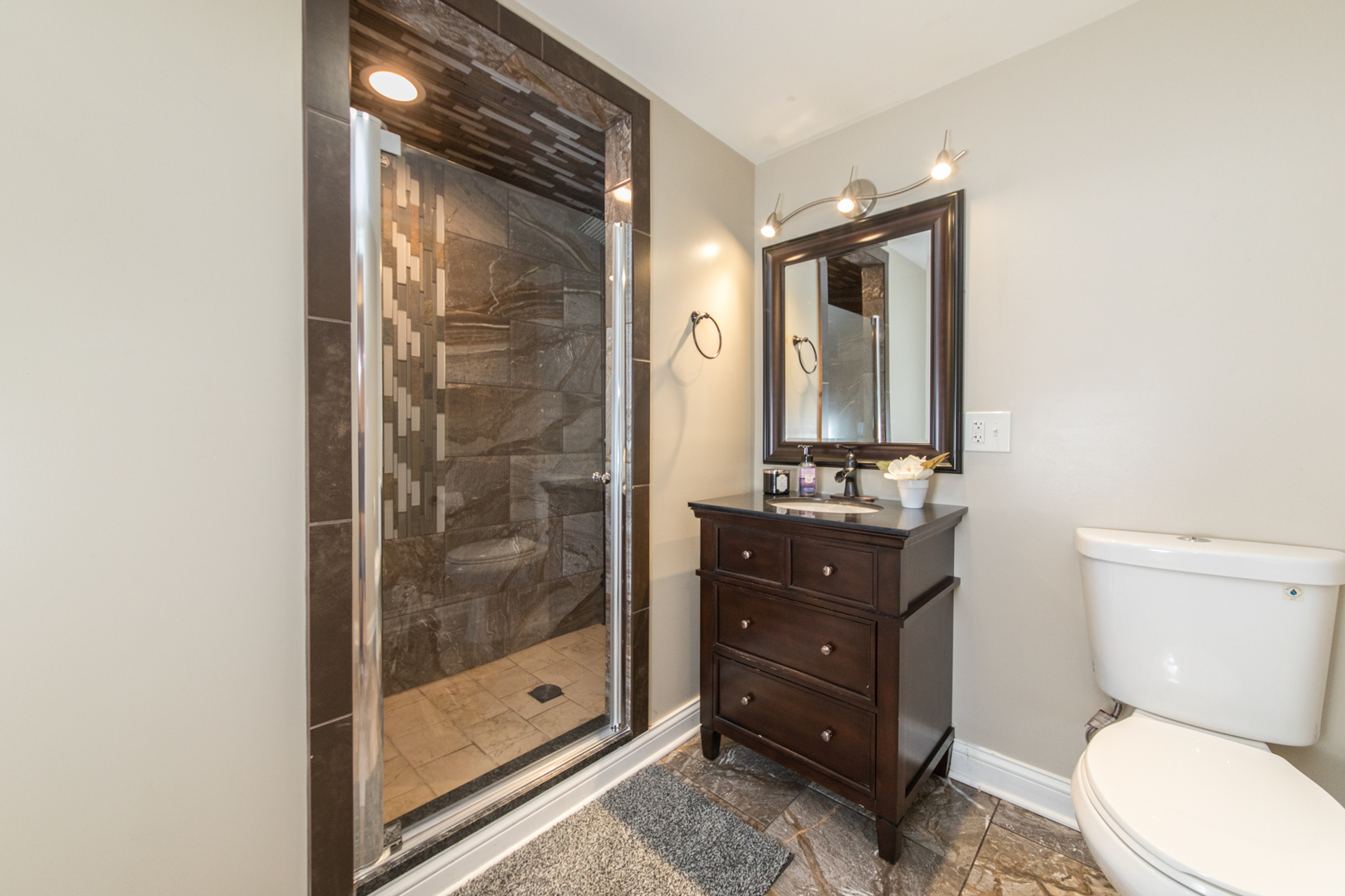 8653 North Merrill Street Niles, IL 60714 - Photo 18 of 19 a bathroom with a toilet a sink and glass door