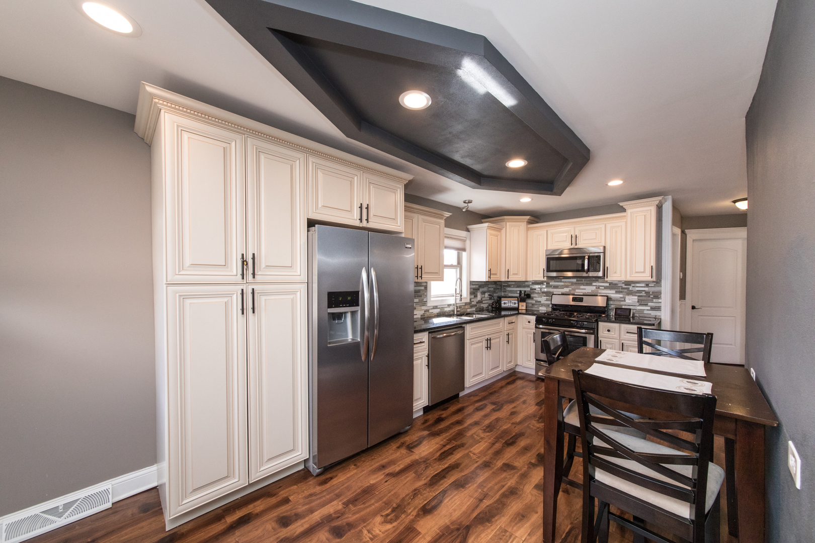 8653 North Merrill Street Niles, IL 60714 - Photo 8 of 19 a kitchen with a refrigerator and a stove top oven