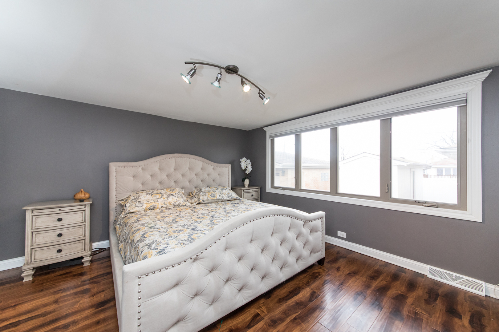 8653 North Merrill Street Niles, IL 60714 - Photo 10 of 19 a bedroom with a large bed and wooden floor