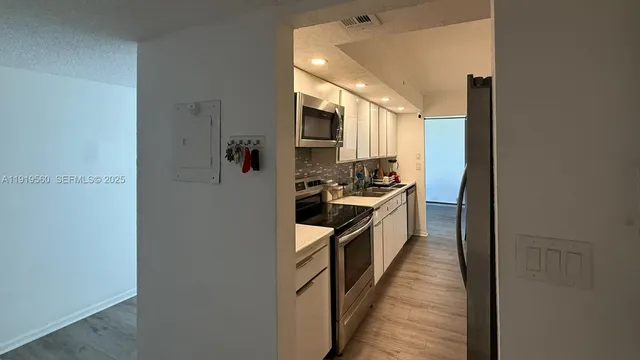 a kitchen with stainless steel appliances a refrigerator and a stove