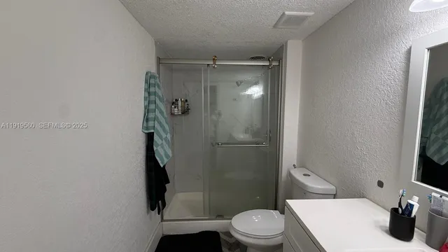 a bathroom with a toilet and a shower