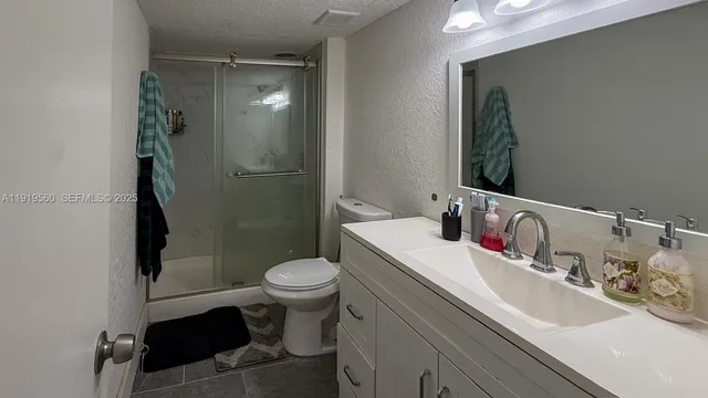 a bathroom with a sink toilet and shower