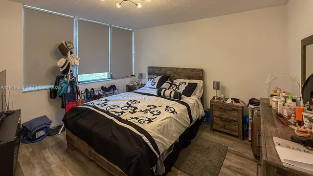 a bedroom with a bed and a mirror