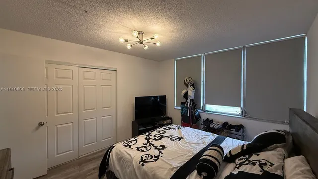 a bedroom with a bed and a chandelier