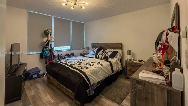 a bed room with a bed and a gym machine