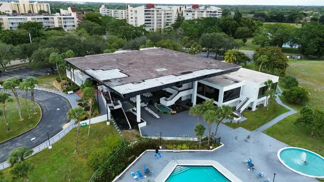 an aerial view of a house with swimming pool garden and patio
