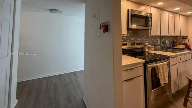 a kitchen with a refrigerator stove and microwave