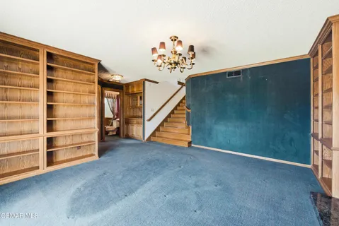 a view of an empty room with stairs