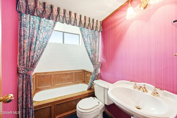 a bathroom with a sink a toilet and bathtub