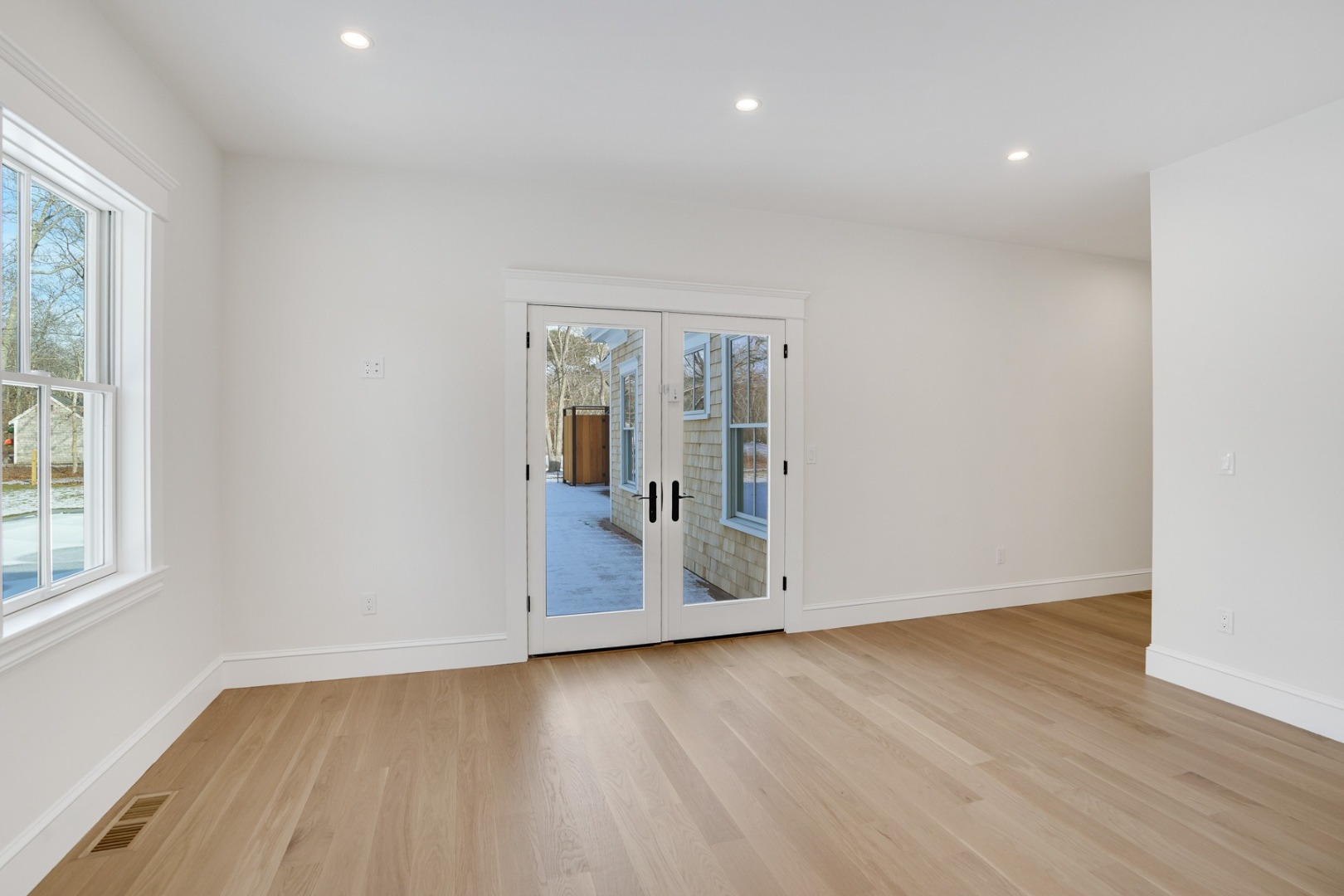 9 Martha's Way Edgartown, MA 02539 - Photo 19 of 41 an empty room with wooden floor and windows