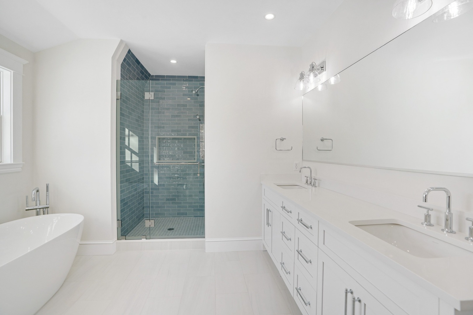 9 Martha's Way Edgartown, MA 02539 - Photo 29 of 41 a bathroom with a double vanity sink a large mirror and a bathtub