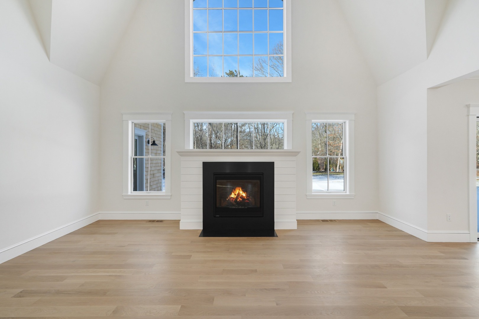 9 Martha's Way Edgartown, MA 02539 - Photo 4 of 41 a view of an empty room with a fireplace and a window