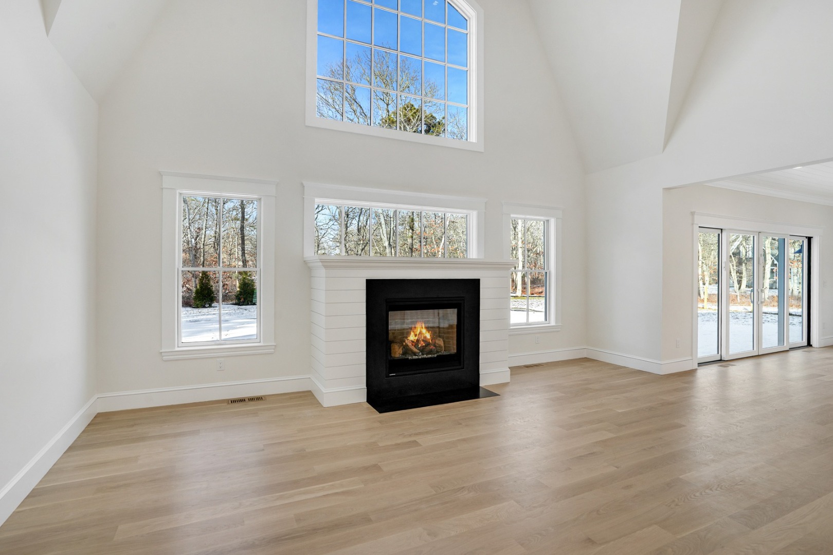 9 Martha's Way Edgartown, MA 02539 - Photo 5 of 41 a view of an empty room with wooden floor fireplace and a window